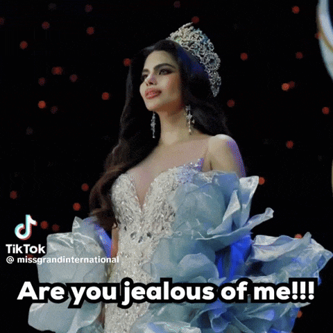 a woman wearing a tiara and a blue dress says " are you jealous of me !!! "