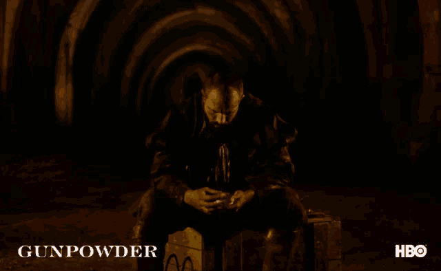 a poster for gunpowder shows a man sitting on a crate