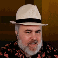 a man with a beard is wearing a hat and ear buds