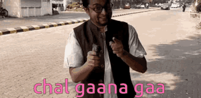 a man standing on a street with the words chal gaana gaa in pink