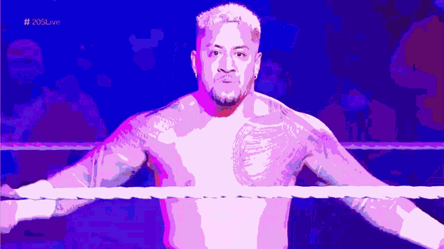 a man in a wrestling ring with the words # 205live on the bottom