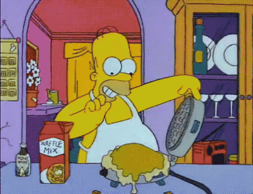 a cartoon of homer simpson making a waffle with waffle mix