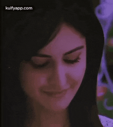 a close up of a woman 's face with a purple background and the words kulfyapp.com on the bottom