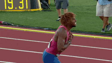 a runner wearing a pink nike tank top with the word oregon on it