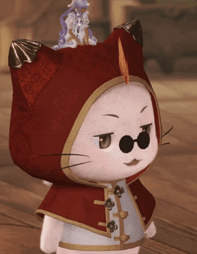a stuffed animal wearing a red cape and glasses