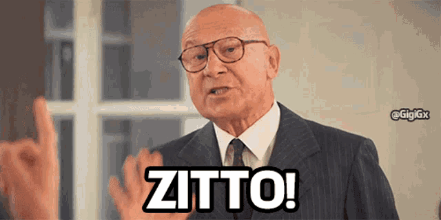 a man in a suit and tie says zitto in black letters
