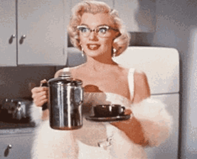 a woman in a white dress is holding a coffee pot and a cup of coffee