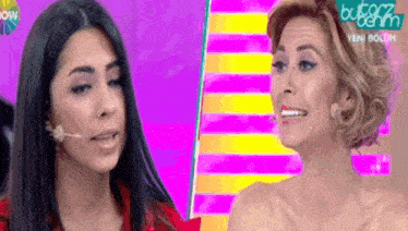 two women are standing next to each other in front of a colorful background with the word wow on it