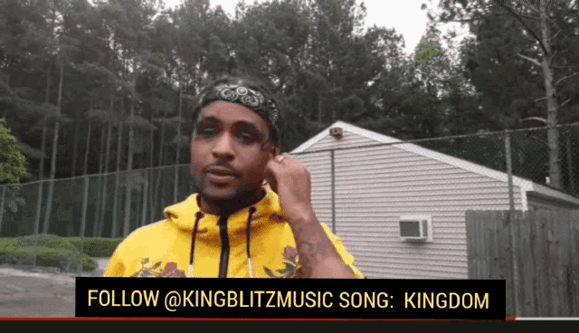 a man wearing a bandana and a yellow hoodie says follow @kingblitzmusic song : kingdom