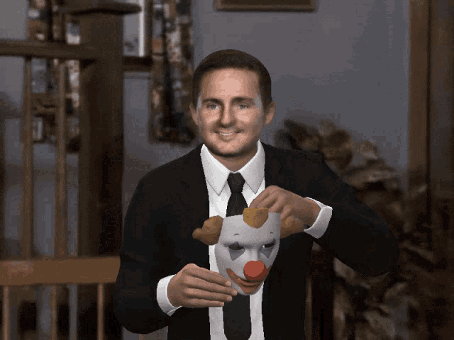 a man in a suit is holding a clown mask