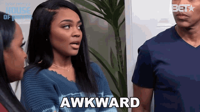 a woman says awkward while standing next to a man and another woman