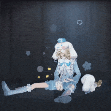 a doll in a blue and white outfit is sitting on the floor