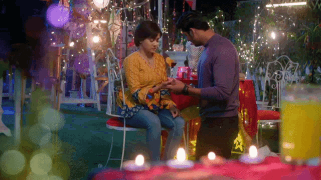 a man is proposing to a woman while she sits on a chair