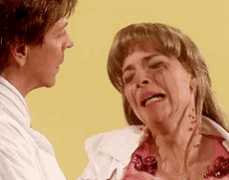 a woman in a pink dress is crying while a man in a white shirt looks on
