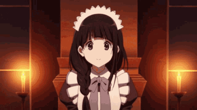 a girl in a maid outfit is sitting in front of a candle