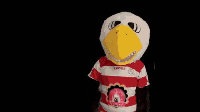 a mascot wearing a red and white striped shirt that says legea on it