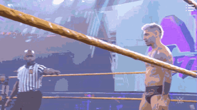 a man in a wrestling ring with the letter w on the bottom