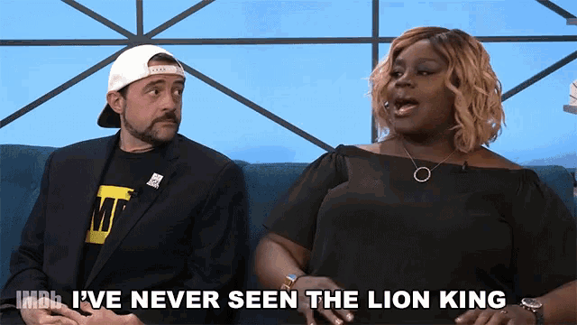 a man and woman are sitting on a couch and the woman says i 've never seen the lion king ..