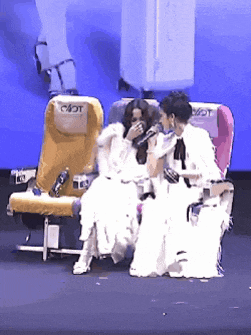 three women in white dresses are sitting in airplane seats with the word jet on the back