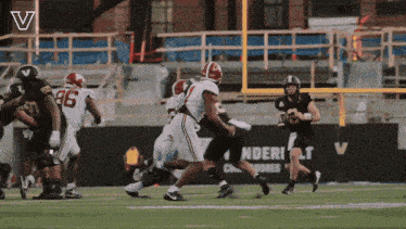a football game is being played in front of a sign that says ' ndert ' on it