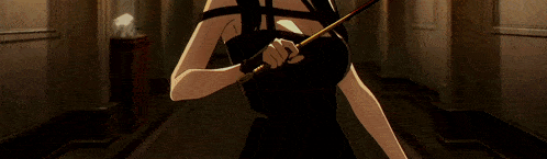 a woman in a black dress holding a wand in a hallway