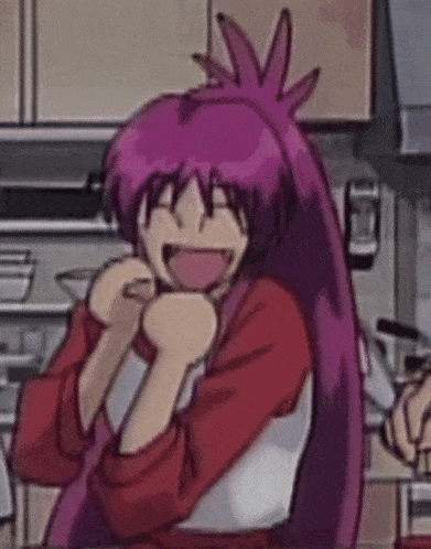 a girl with purple hair is laughing in a kitchen while wearing an apron .