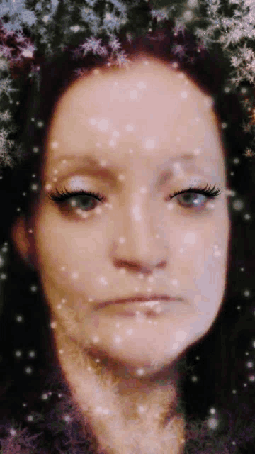 a woman with snowflakes on her face looks sad
