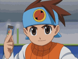 a boy wearing a blue headband holds up a small item
