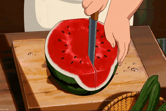 a person is cutting a watermelon on a cutting board with a knife