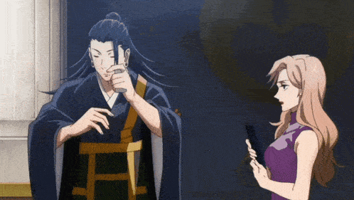 a man and a woman are standing next to each other and the woman is holding a cell phone