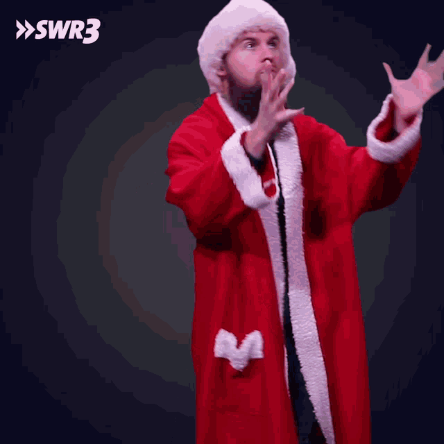 a man in a santa claus costume is blowing money in the air