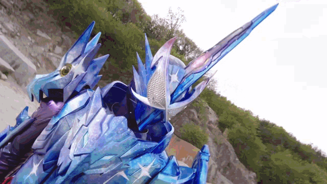 a person in a blue costume with a sword