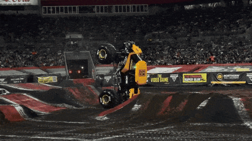 a monster truck is jumping in front of a lucas oil sign