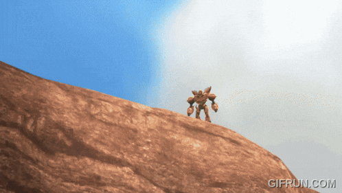 a gif from gifrun.com shows a robot on top of a rock