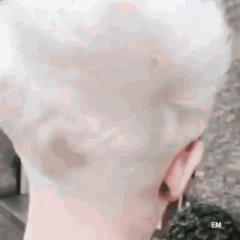 a close up of a person 's head with a shaved head .