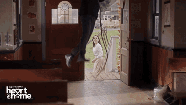 a super channel ad for heart & home shows a man and woman jumping