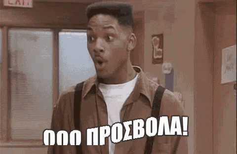 a man with a surprised look on his face is standing in a hallway with a foreign language .