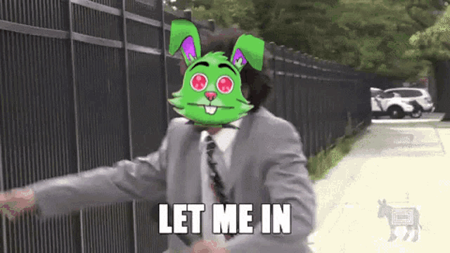 a man in a suit and tie with a green rabbit mask on his face says let me in .