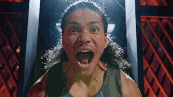 a man with long hair screams with his mouth open