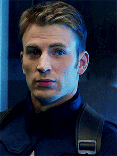 a close up of a man 's face with a strap on his back