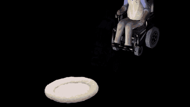 a man in a wheelchair is being pushed by another person