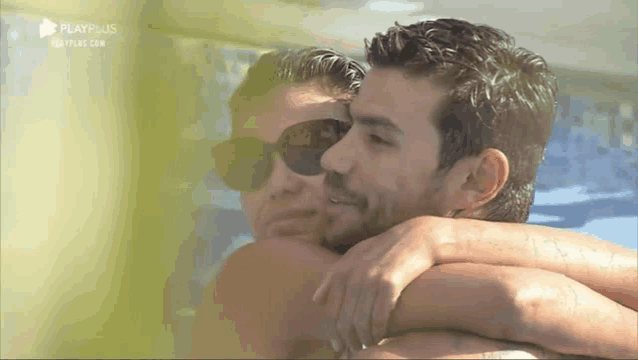 a man is carrying a woman on his back in a pool .