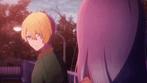 a boy with blonde hair and blue eyes is standing next to a girl with white hair