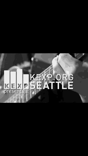 a black and white photo of a person playing a guitar with the words kexp.org presents seattle