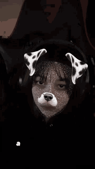 a girl wearing dalmatian ears and a black hat