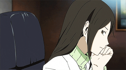 a woman with long brown hair is sitting in a chair