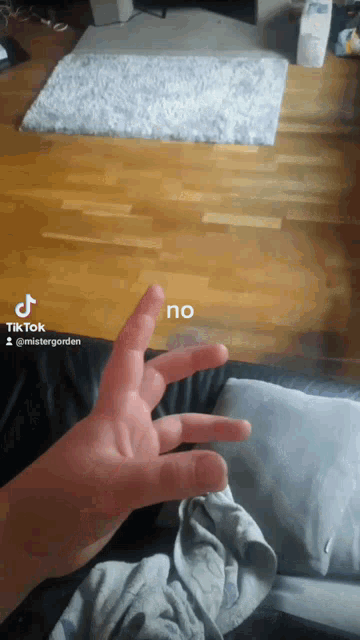 a tiktok video of a person 's hand with the word no written on it