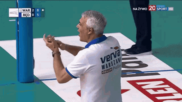 a man wearing a shirt that says verva warszawa on it