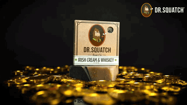 a box of dr. squatch irish cream and whiskey soap surrounded by gold coins
