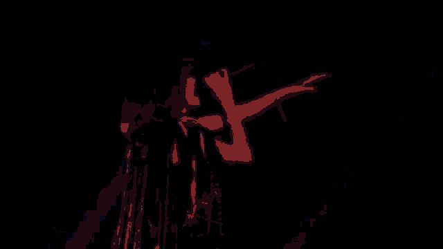 a woman is singing into a microphone on a stage in front of a blue sky .